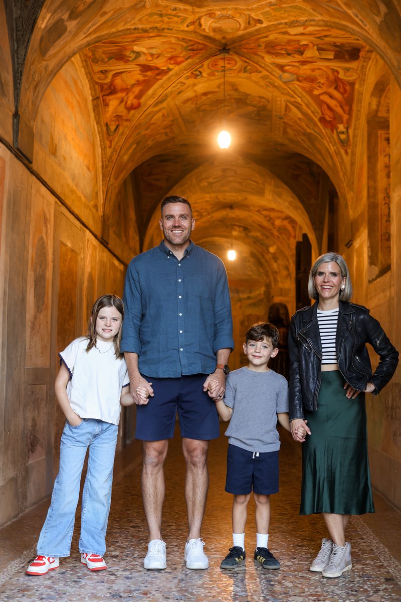 Brendan and his family in a painted hallway in Pistoia, Italy